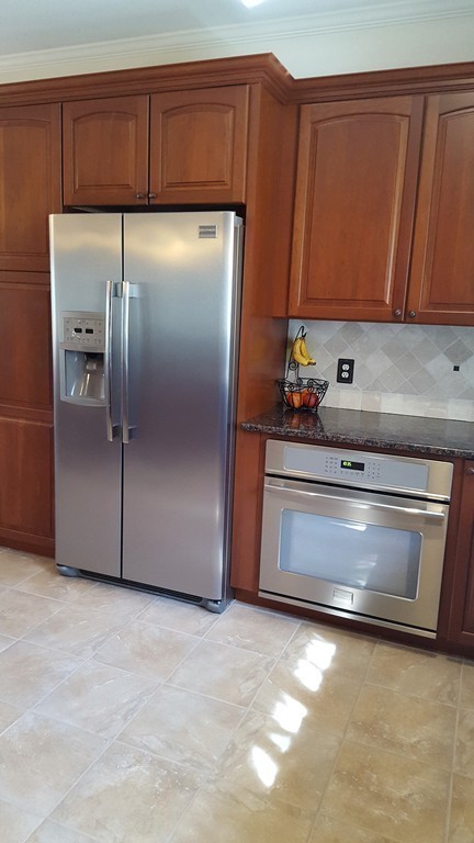 256 Hovey Road Monson, MA 01057 - Photo 17 of 27 a kitchen with granite countertop stainless steel appliances and wooden cabinets