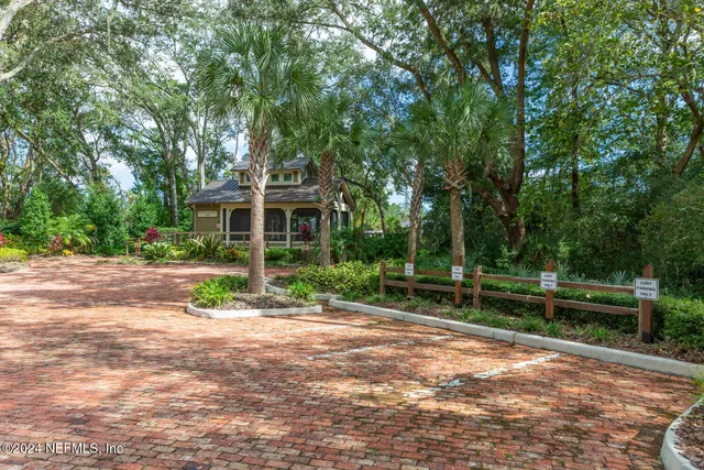 an aerial view of lake residential house with outdoor space and trees around