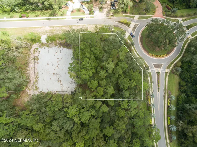 a view of green field with trees in the background