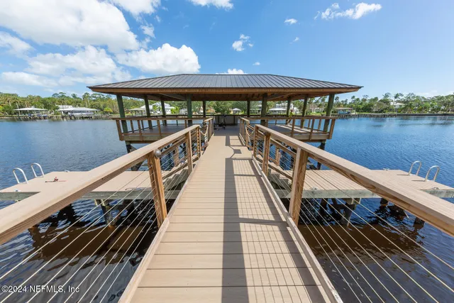 a view of balcony with wooden floor and lake view