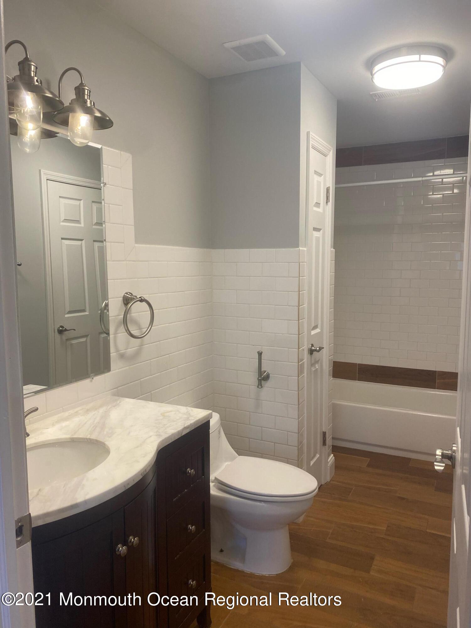 506 Harding Road, Unit 3 Freehold, NJ 07728 - Photo 14 of 18 a bathroom with a sink a toilet and shower