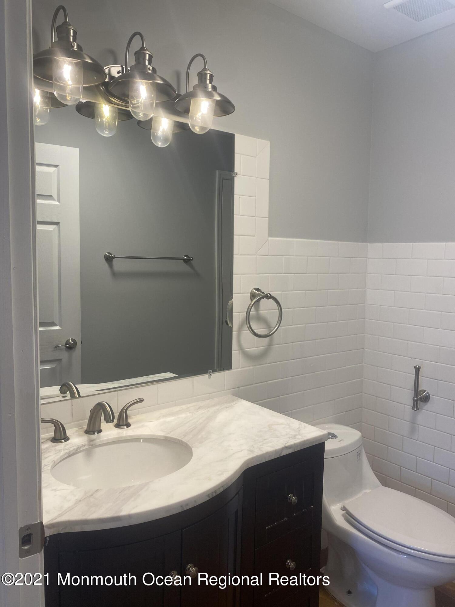 506 Harding Road, Unit 3 Freehold, NJ 07728 - Photo 16 of 18 a bathroom with a sink and a mirror