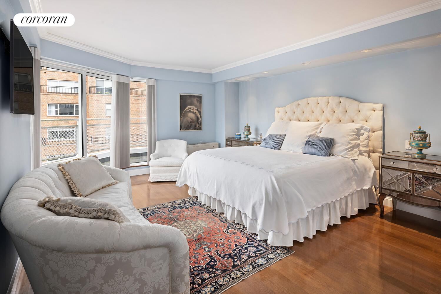 30 East 65th Street, Unit 15A Manhattan, NY 10065 - Photo 10 of 13 a spacious bedroom with a bed and a large window