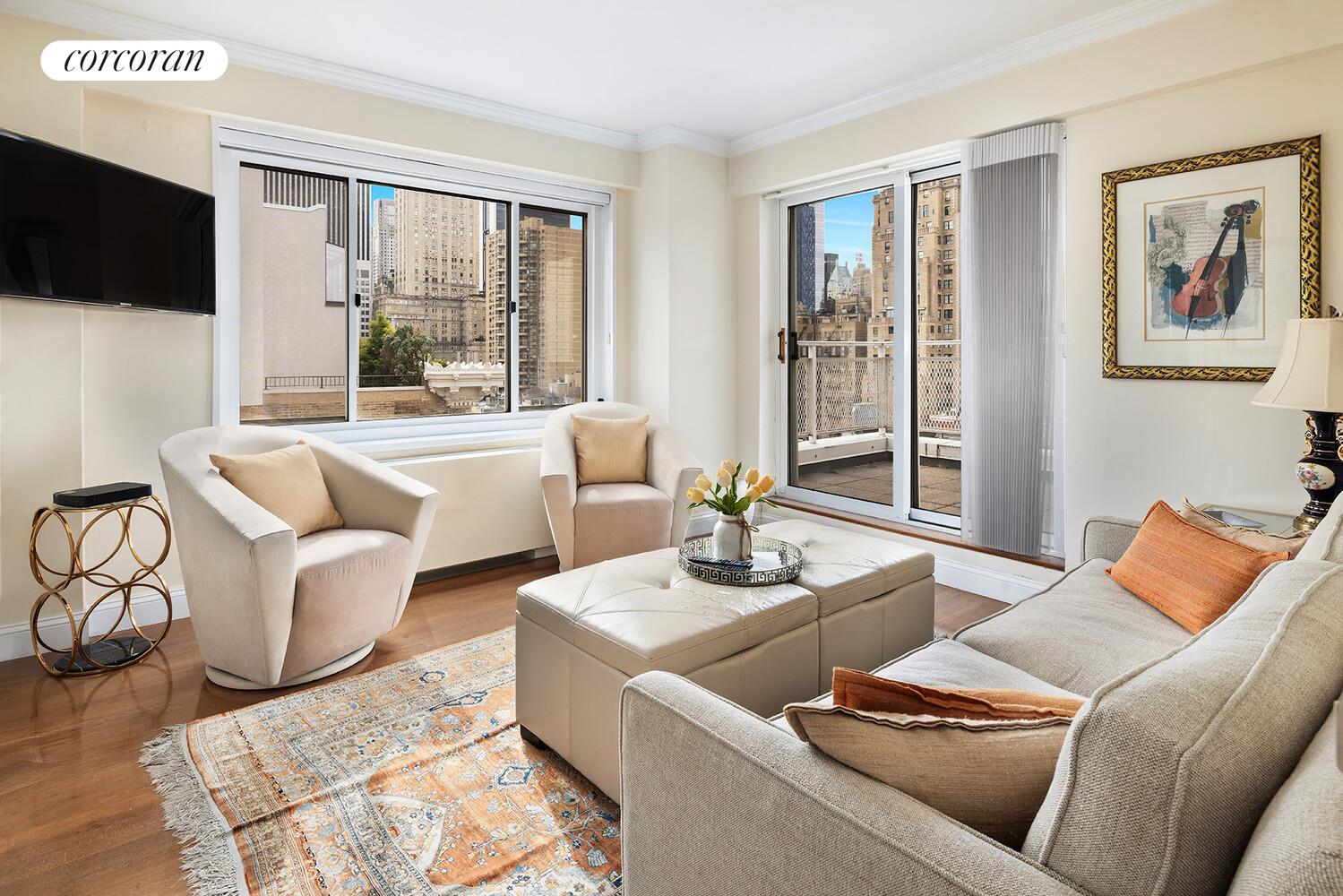 30 East 65th Street, Unit 15A Manhattan, NY 10065 - Photo 8 of 13 a living room with furniture and a flat screen tv