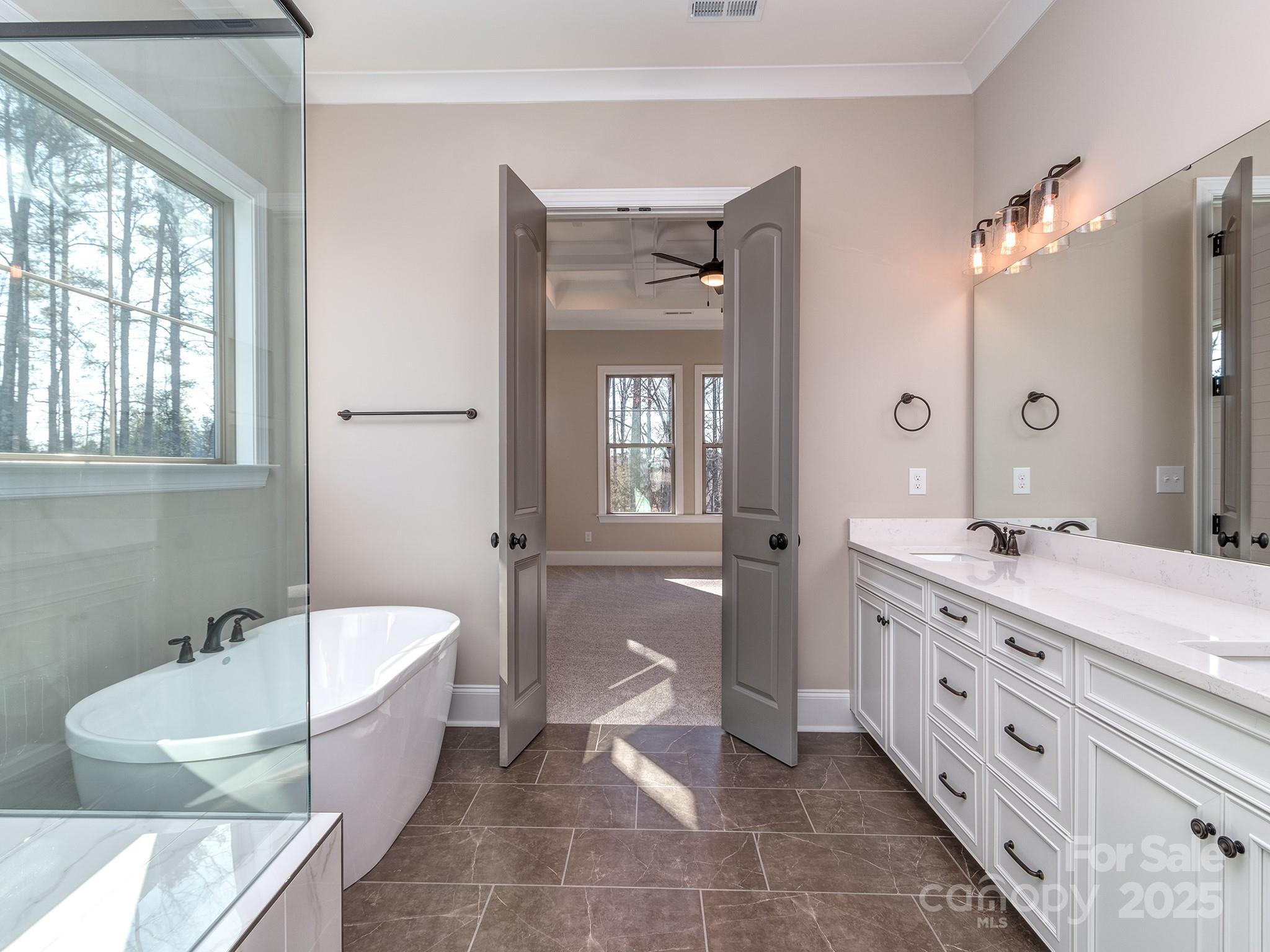 11055 Holiday Cove Lane Tega Cay, SC 29708 - Photo 13 of 39 a bathroom with a tub sink and mirror