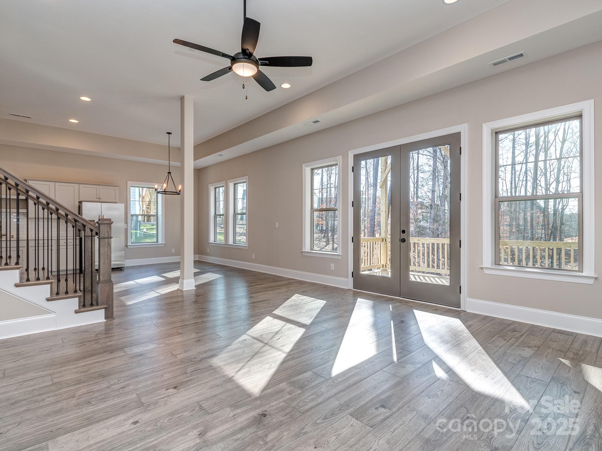 11055 Holiday Cove Lane Tega Cay, SC 29708 - Photo 21 of 39 a view of an entryway with wooden floor and windows