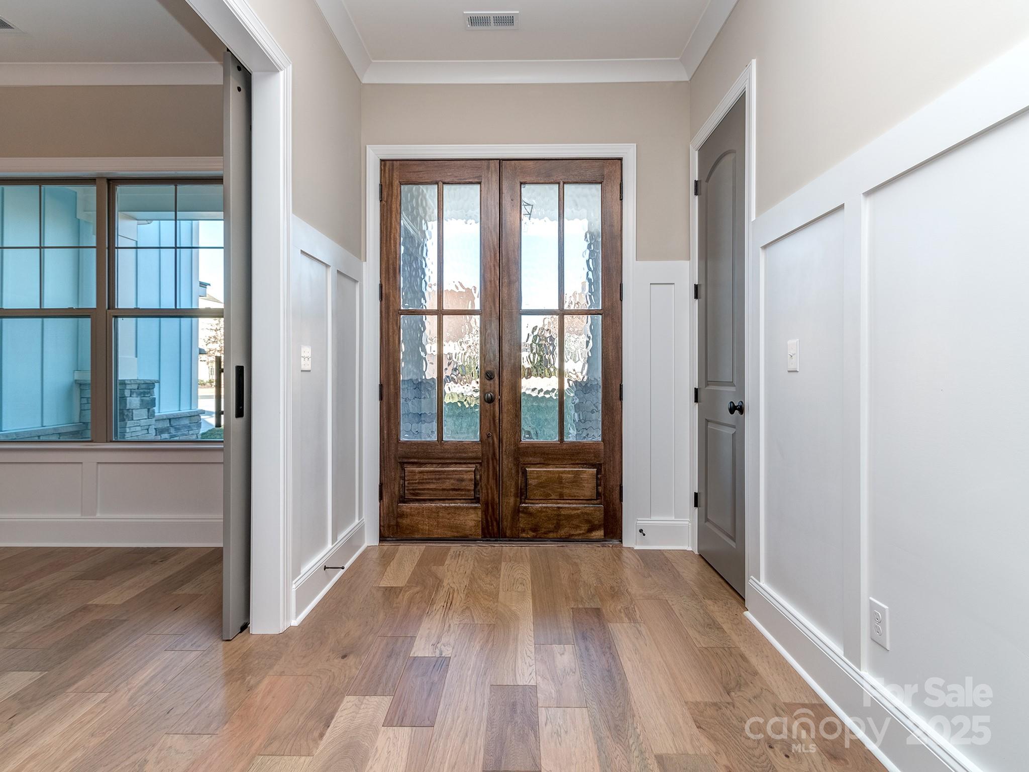 11055 Holiday Cove Lane Tega Cay, SC 29708 - Photo 3 of 39 an empty room with wooden floor and windows