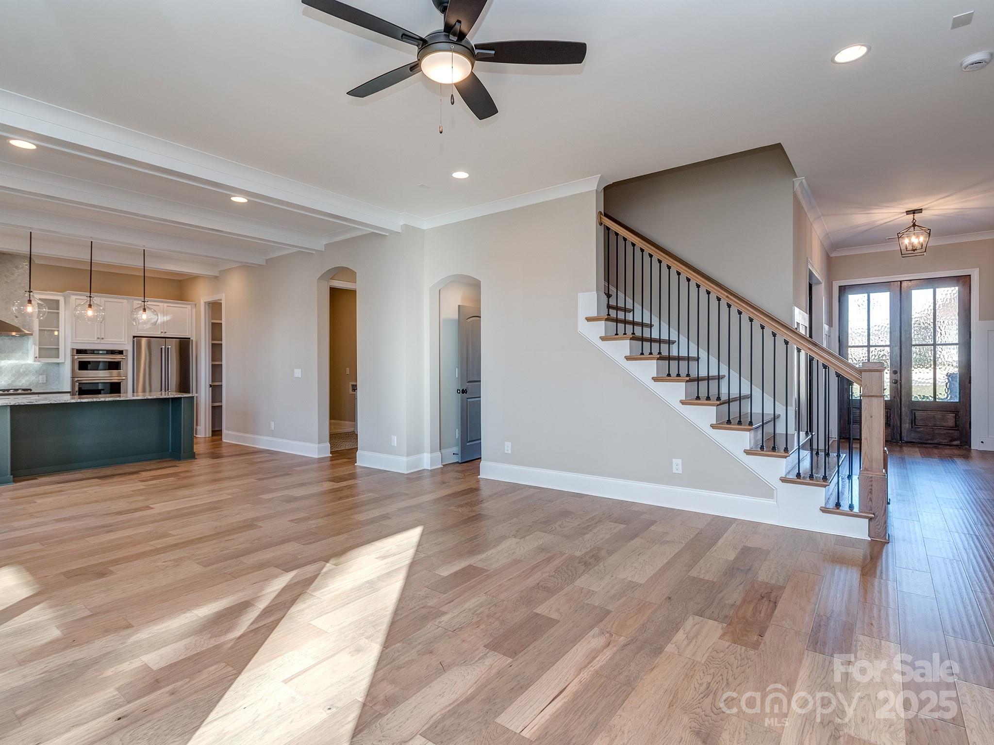 11055 Holiday Cove Lane Tega Cay, SC 29708 - Photo 5 of 39 a view of a hallway with wooden floor and staircase