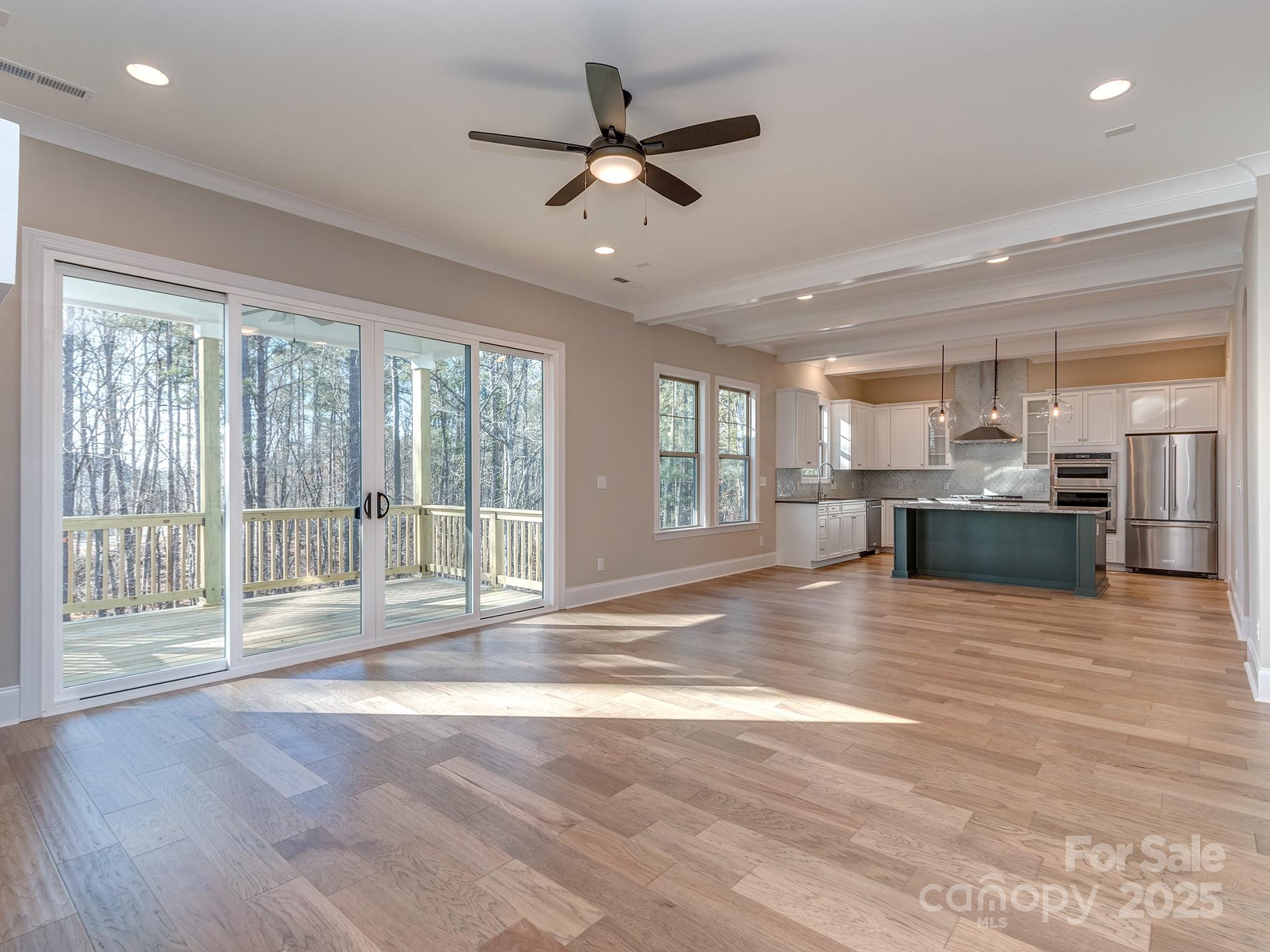 11055 Holiday Cove Lane Tega Cay, SC 29708 - Photo 6 of 39 a view of an empty room with wooden floor and a window