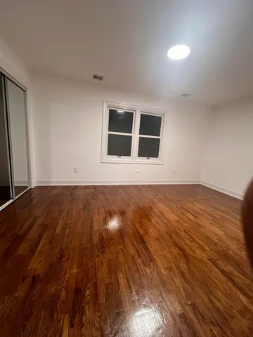 a bathroom with a granite countertop toilet sink and mirror