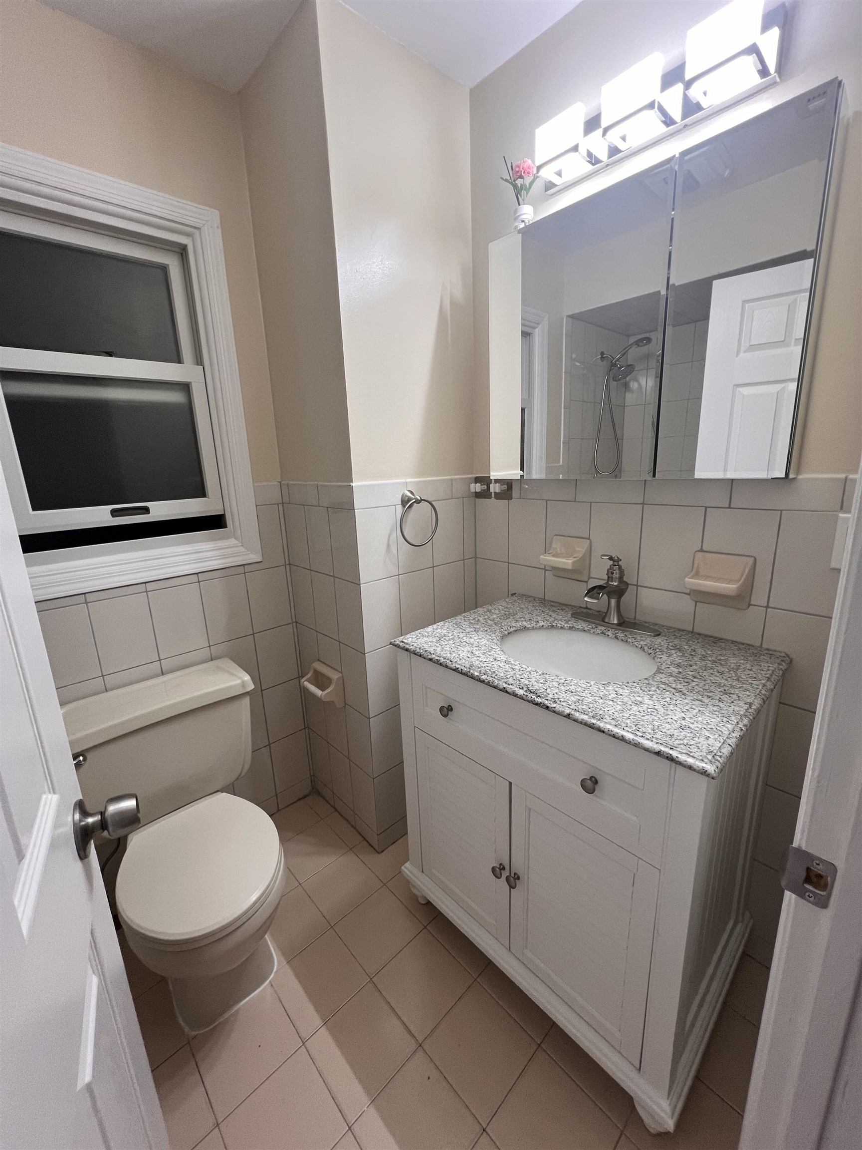 1302 Morris Street Union City, NJ 07087 - Photo 12 of 12 a bathroom with a granite countertop toilet sink and mirror