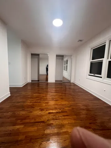 a view of room with wooden floor