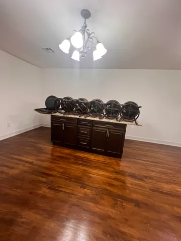 a view of a room with wooden floor