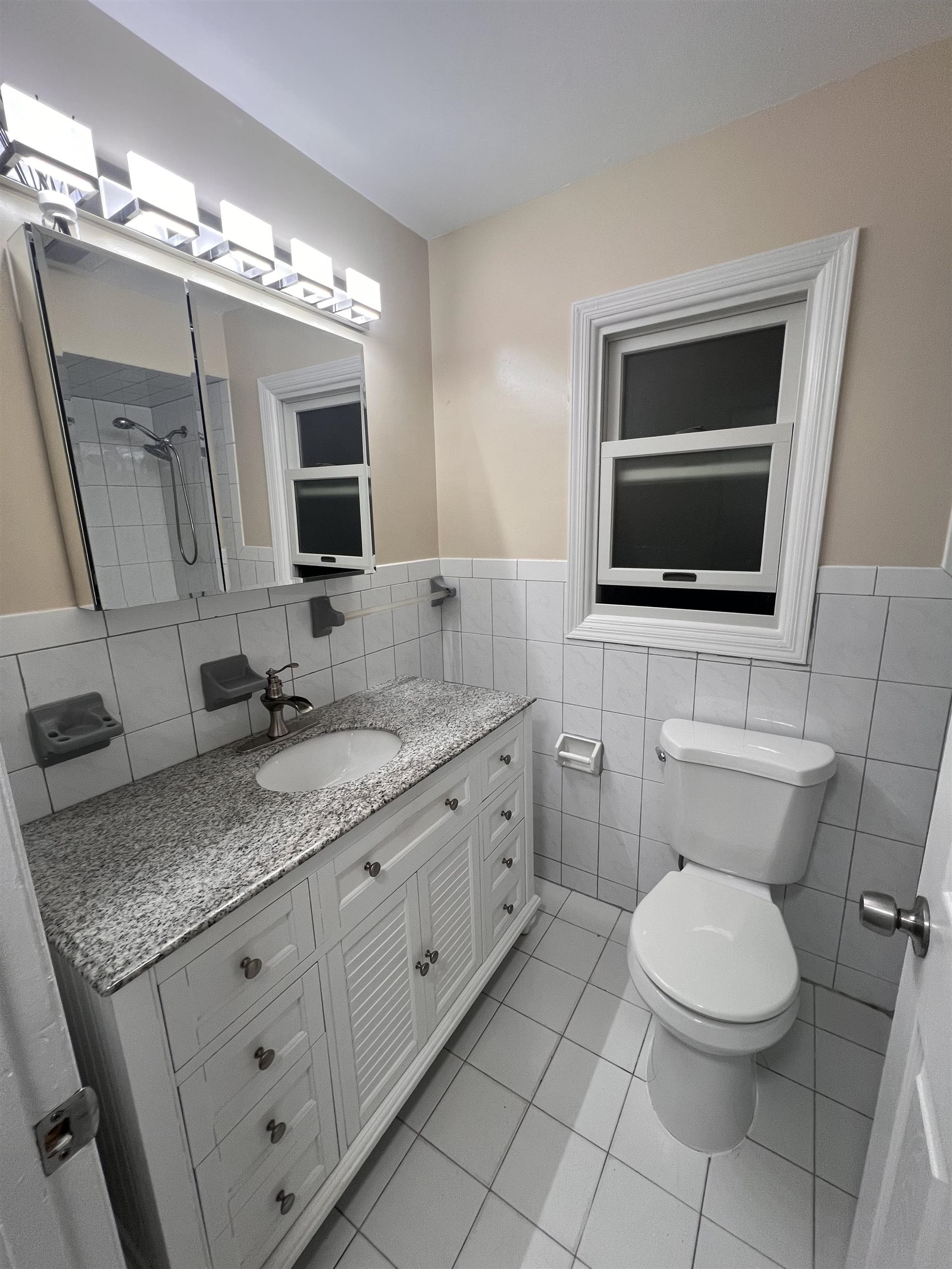 1302 Morris Street Union City, NJ 07087 - Photo 6 of 12 a bathroom with a granite countertop toilet sink and mirror