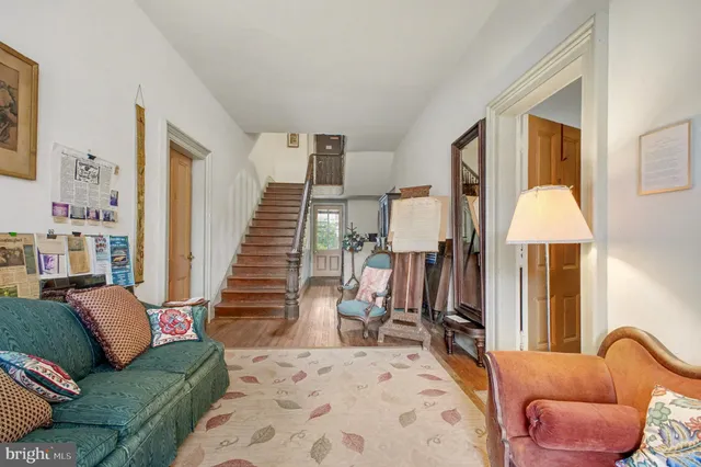 a living room with furniture fireplace and a window
