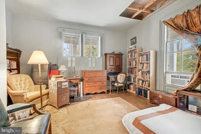 a living room with furniture gym equipment and a window