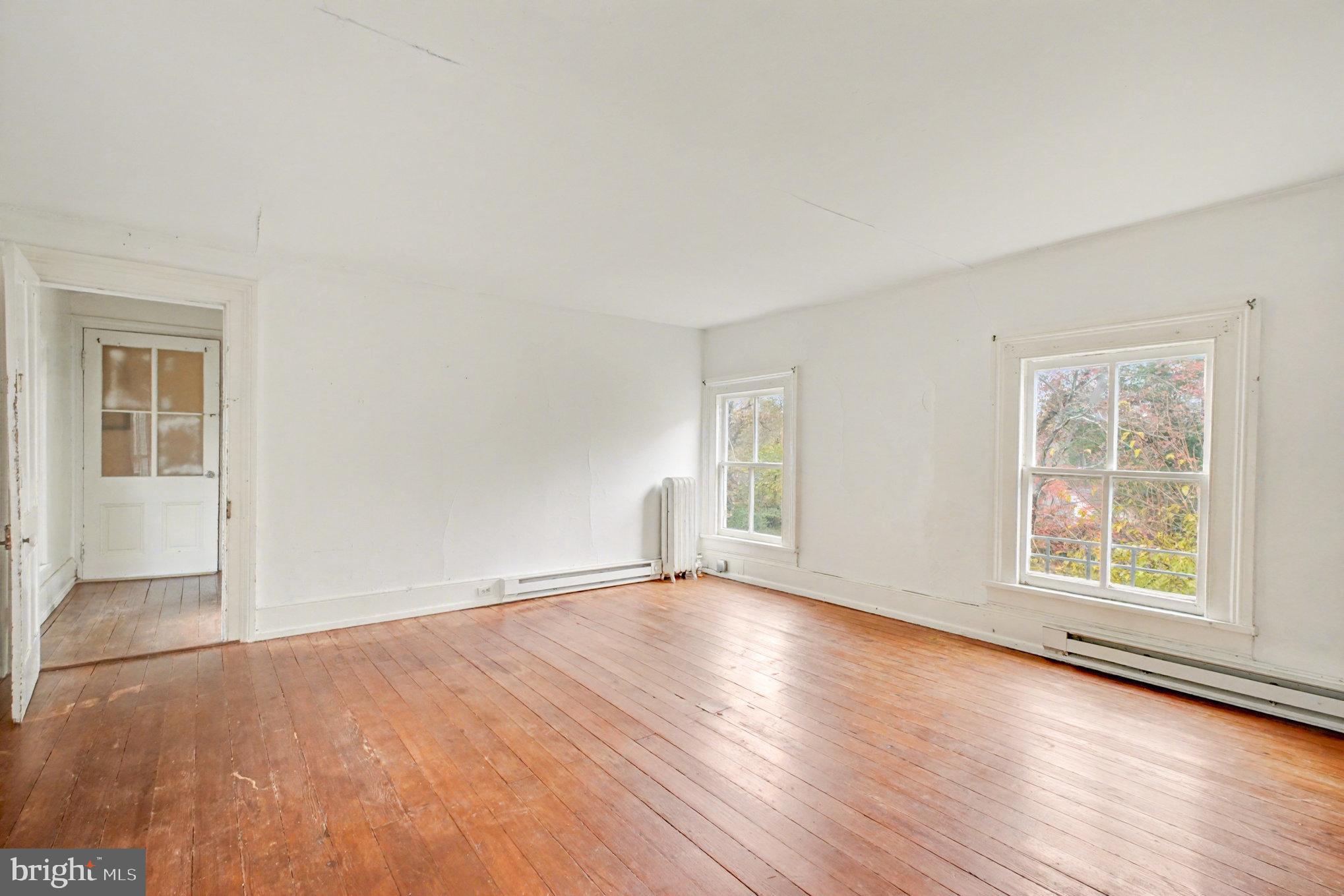 900 Ficklen Road Fredericksburg, VA 22405 - Photo 20 of 46 an empty room with wooden floor and windows