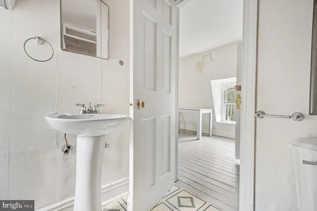 a bathroom with a sink a mirror and shower