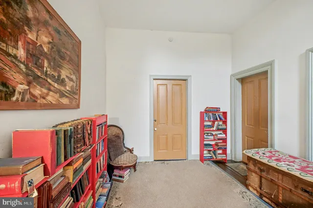 a bedroom with furniture and a book shelf