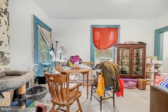 a living room with furniture a rug and a floor to ceiling window