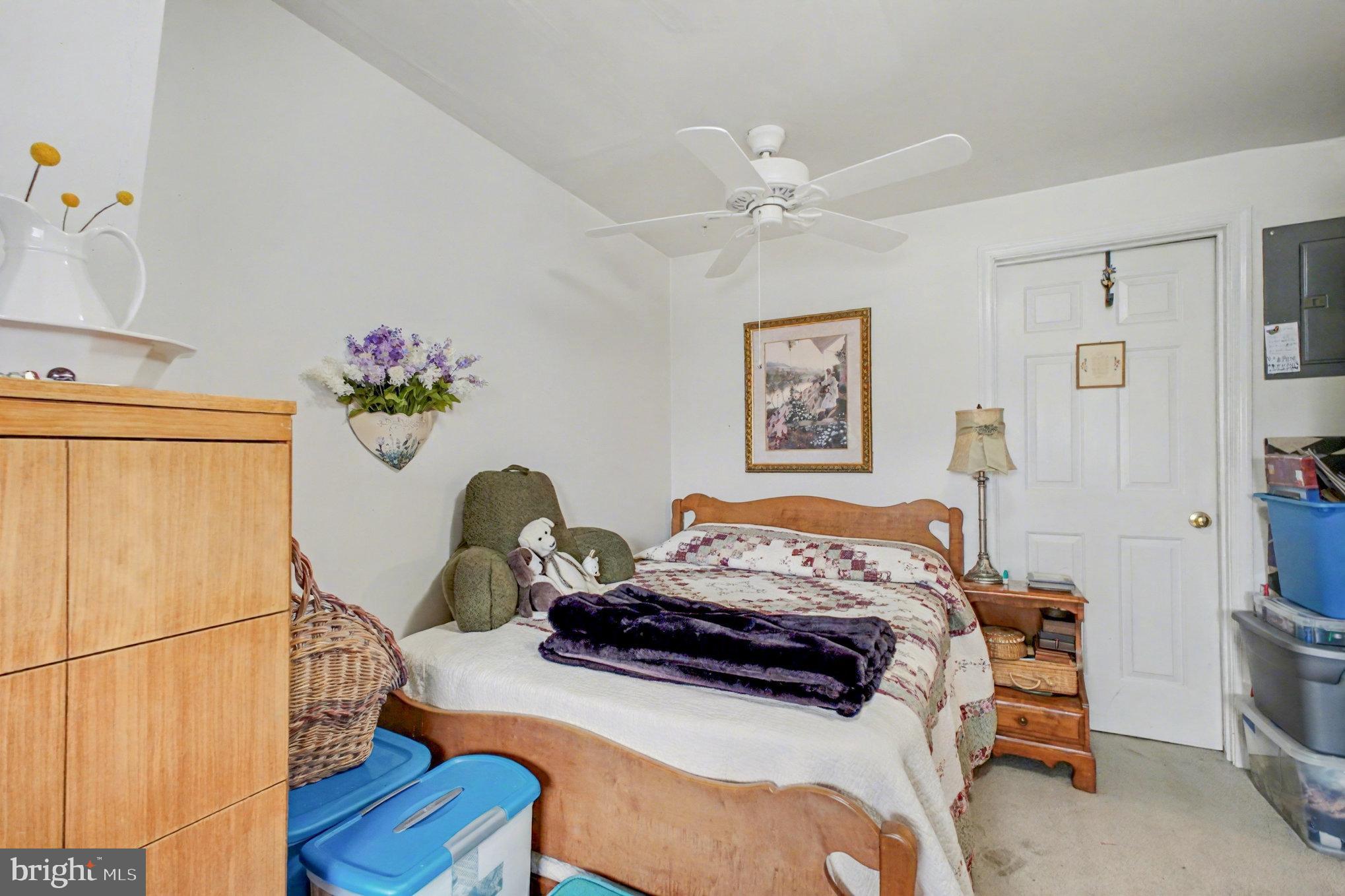 900 Ficklen Road Fredericksburg, VA 22405 - Photo 35 of 46 a bedroom with a bed and a chandelier