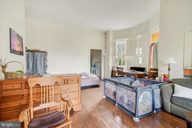 a living room with furniture a fireplace and wooden floor