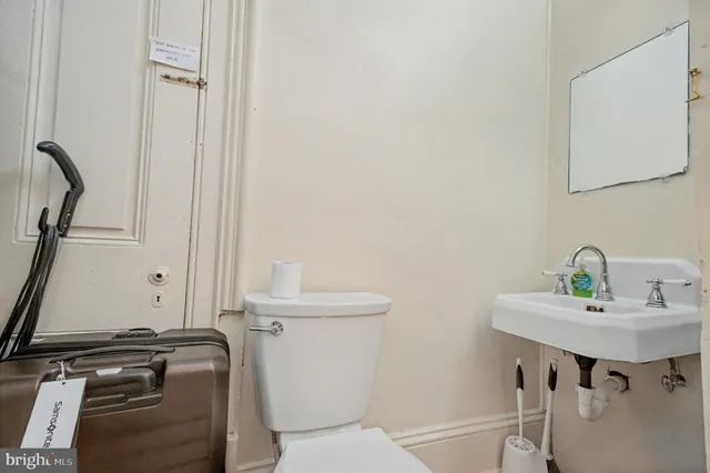 a bathroom with a sink a toilet and a mirror