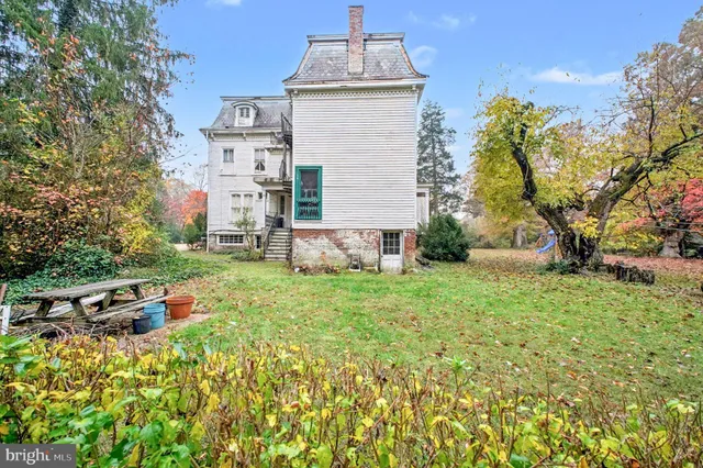 a backyard of a house with lots of green space and fountain