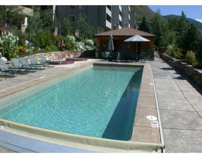 625 North Frontage Road West, Unit 21 Vail, CO 81657 - Photo 4 of 8 a view of a patio with a table and chairs under an umbrella