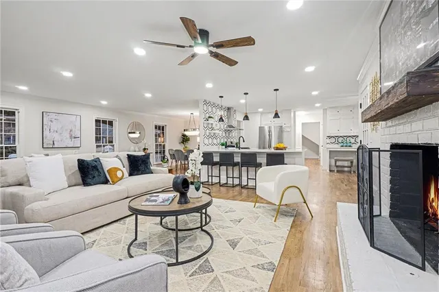 a living room with furniture kitchen view and a fireplace