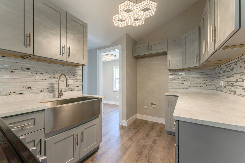 2330 121st Street Blue Island, IL 60406 - Photo 14 of 33 a kitchen with granite countertop a sink stainless steel appliances and cabinets