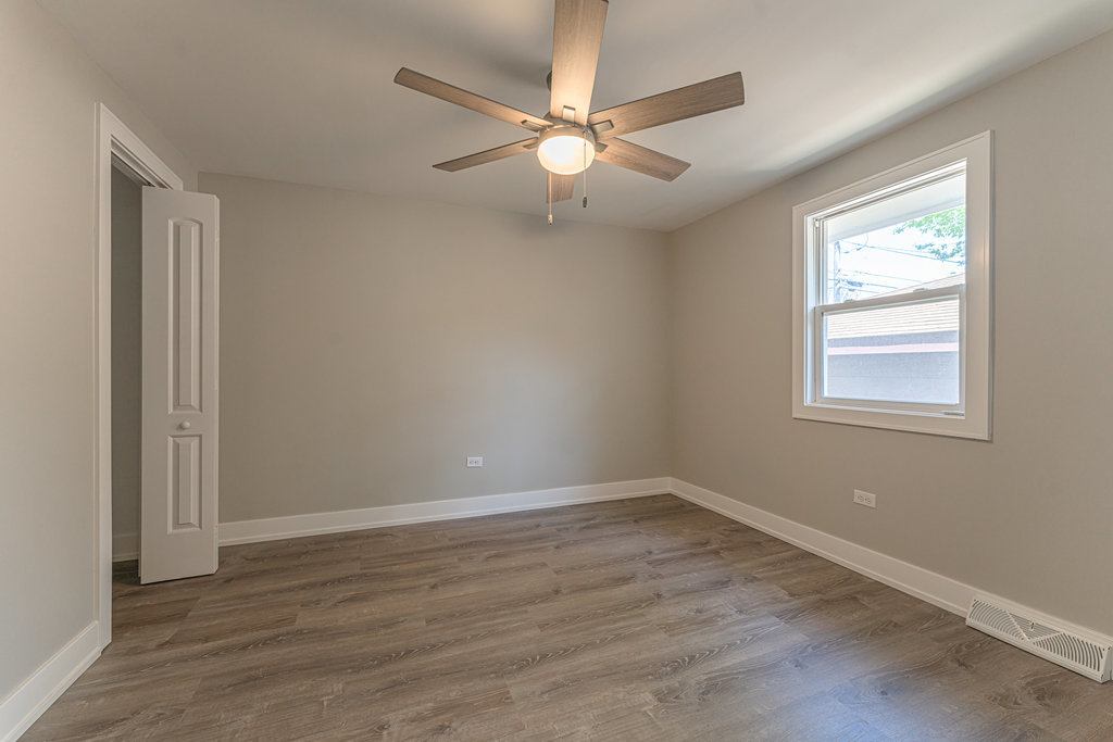 2330 121st Street Blue Island, IL 60406 - Photo 21 of 33 wooden floor in an empty room with a window