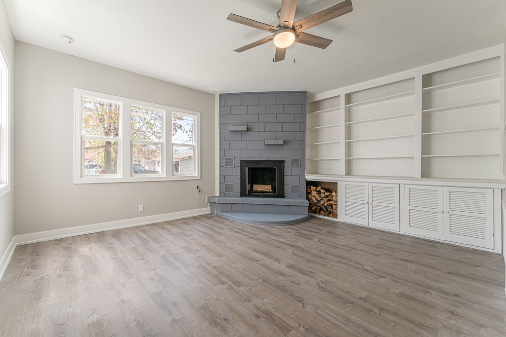 2330 121st Street Blue Island, IL 60406 - Photo 24 of 33 an empty room with windows fireplace and fans