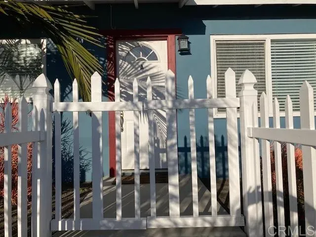 a view of a back yard of the house with a bench