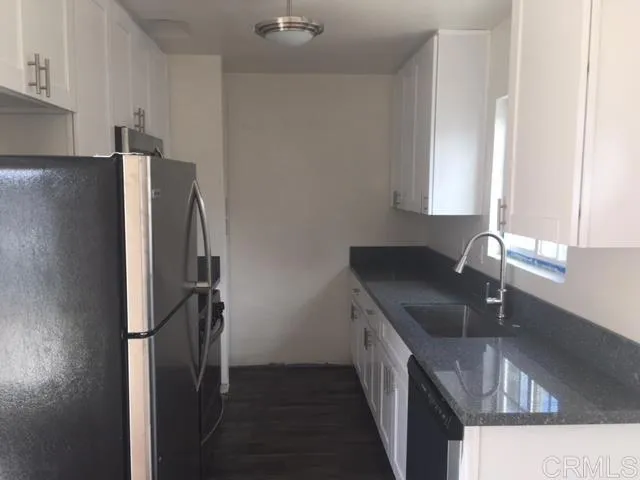 1402 Dubuque Street Oceanside, CA 92058 - Photo 8 of 21 a kitchen with a refrigerator and a sink
