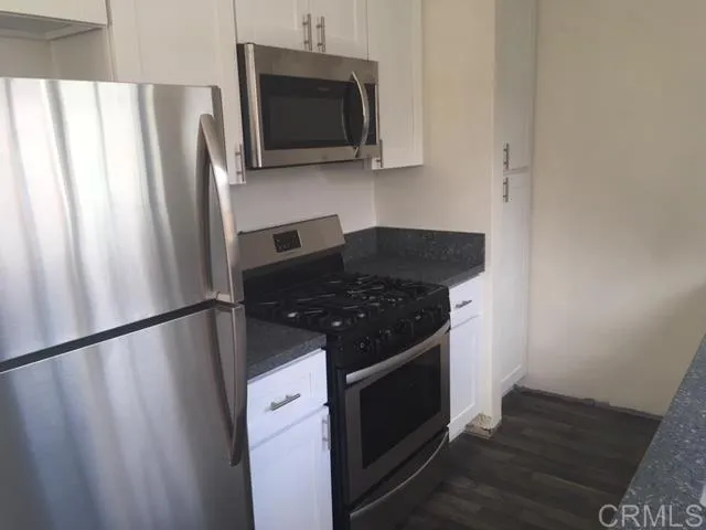 1402 Dubuque Street Oceanside, CA 92058 - Photo 10 of 21 a kitchen with a refrigerator stove and microwave
