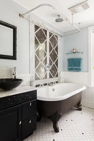 a spacious bathroom with a sink and a mirror