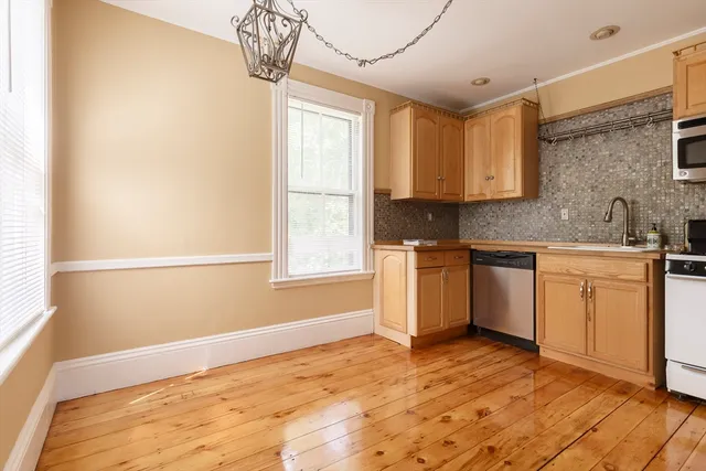 a kitchen with a sink cabinets appliances and a window