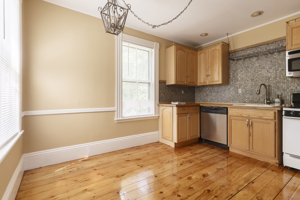 327 Lafayette Street, Unit 2 Salem, MA 01970 - Photo 17 of 22 a kitchen with a sink cabinets appliances and a window