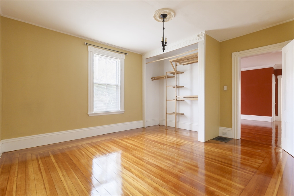 327 Lafayette Street, Unit 2 Salem, MA 01970 - Photo 22 of 22 a view of an empty room with wooden floor and a window