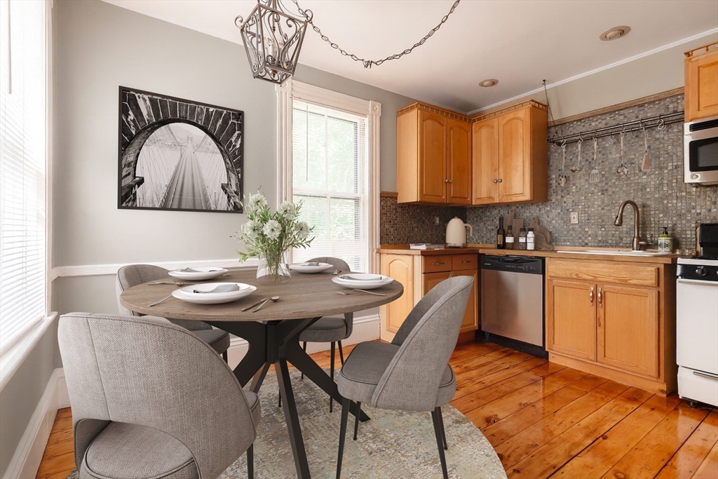 327 Lafayette Street, Unit 2 Salem, MA 01970 - Photo 4 of 22 a kitchen with a table chairs sink and cabinets