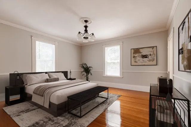 a bedroom with bed and wooden floor