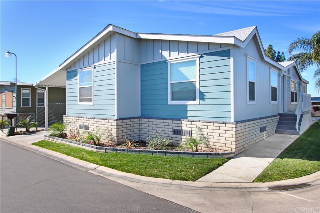 1155 Riverside Avenue, Unit 63 Rialto, CA 92376 - Photo 1 of 1 a front view of a house with a yard and garage