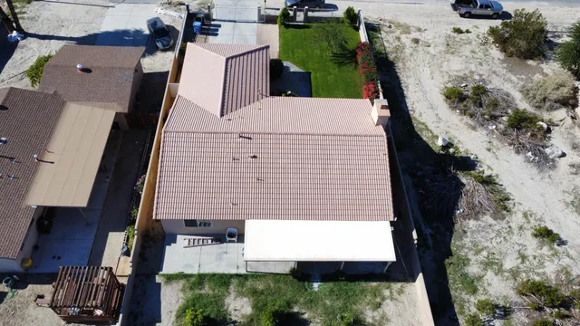 an aerial view of a house with a yard