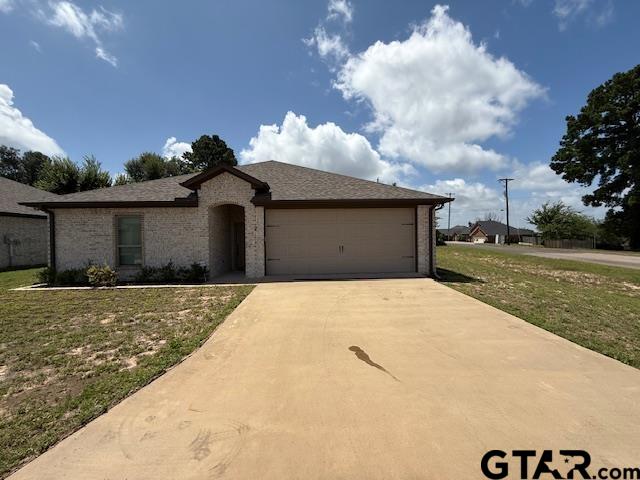 16461 County Road 178, Unit 2 Tyler, TX 75703 - Photo 1 of 16 a front view of a house with a yard and garage