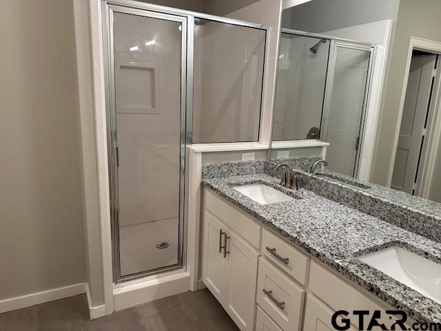 16461 County Road 178, Unit 2 Tyler, TX 75703 - Photo 11 of 16 a bathroom with a granite countertop sink and a mirror