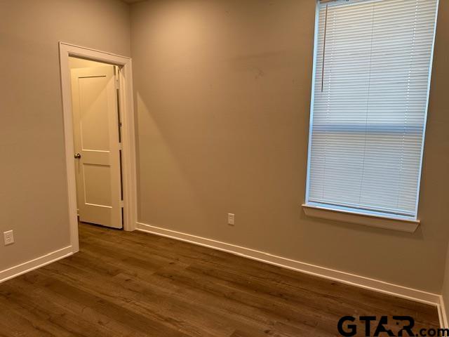 16461 County Road 178, Unit 2 Tyler, TX 75703 - Photo 15 of 16 an empty room with wooden floor and closet