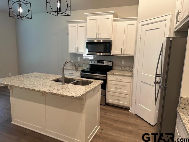 16461 County Road 178, Unit 2 Tyler, TX 75703 - Photo 3 of 16 a kitchen with granite countertop a sink stainless steel appliances and cabinets