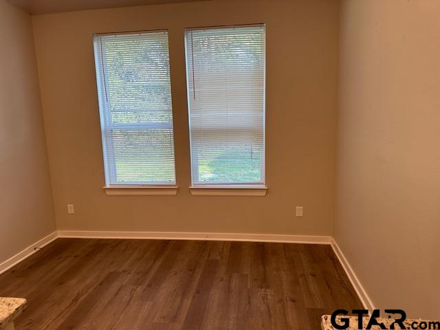 16461 County Road 178, Unit 2 Tyler, TX 75703 - Photo 5 of 16 a view of an empty room with wooden floor and a window