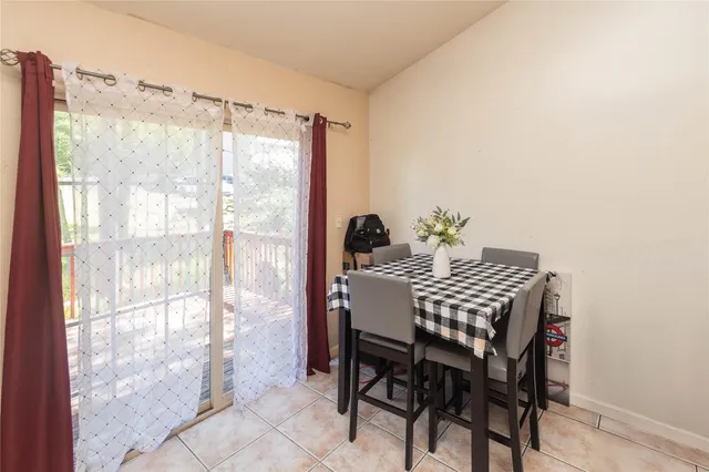 a view of a dining room with furniture and a window